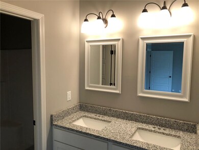Master bath with granite double vanity and walk-in