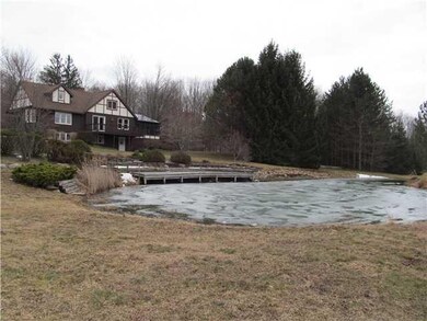 Exterior Front Side view with the pond