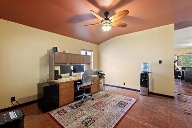Tiled office space with ceiling fan, baseboards, 