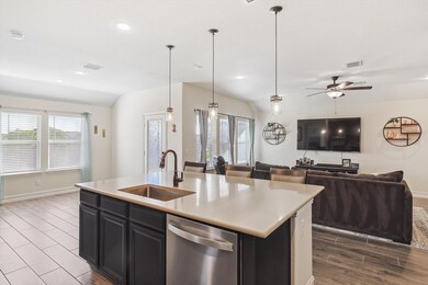 Kitchen featuring sink, an island with sink, hangi
