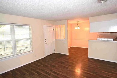 Unfurnished living room featuring a chandelier, d