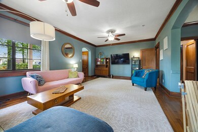 Living area featuring arched walkways, wood finish