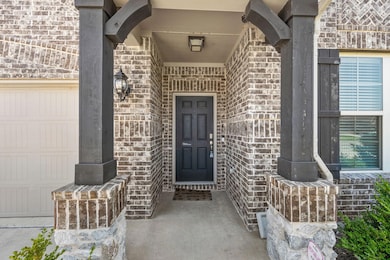 Doorway to property featuring a garage