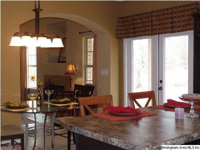 Pretty nook w designer chandelier, french doors to