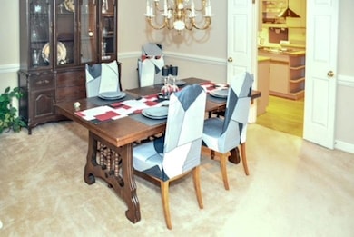 Dining room featuring an inviting chandelier and w