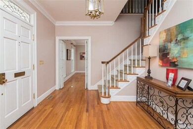 Spacious entry hall with hardwoods.