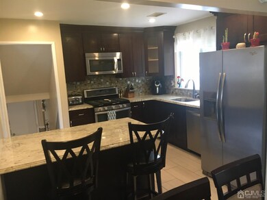 Open concept kitchen with island open to dining ro