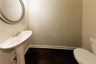 Bathroom with toilet and wood finished floors