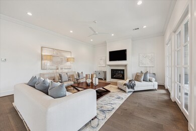 This spacious living room features a corner firepl