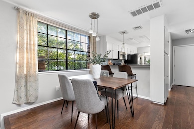 Dining space featuring dark wood-style flooring, 
