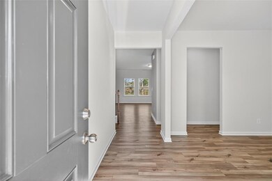 Corridor featuring light wood finished floors and baseboards