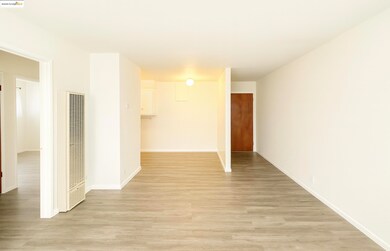 Spare room with a heating unit and light wood finished floors