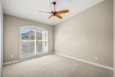 Unfurnished room with baseboards, a ceiling fan, a