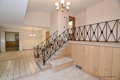 Extra wide staircase and hallway with a decorative