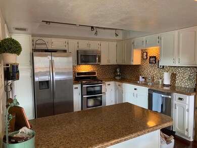 Kitchen with stainless steel appliances, a sink, 