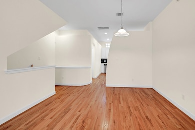 This photo shows a bright, open-concept living are
