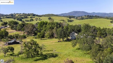 Aerial view featuring a rural view and a mountain view