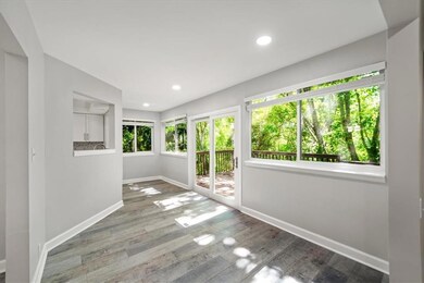 Unfurnished room with baseboards, wood finished floors, and recessed lighting