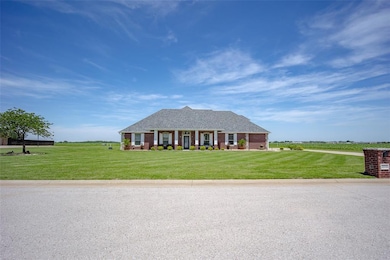 Ranch-style home featuring a front yard, brick sid