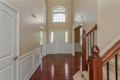 2 story gleaming hardwood entry with library type paneling