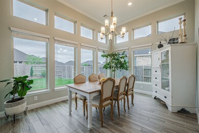 The dining area overlooks the sweeping yard. Custom blinds are already installed and STAY with the sale.