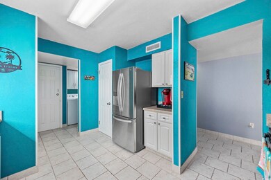 Kitchen featuring stainless steel refrigerator wit