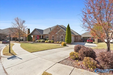 Attached 3 car garage with large concrete driveway, perfect for parking and storage.