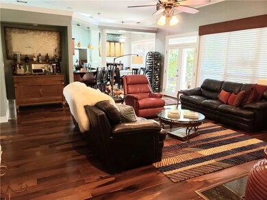 Family Room With Wall of Windows Looking Out To Lu