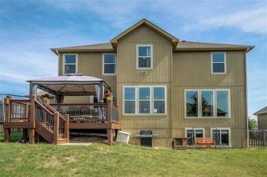 Back of house.  Deck located off the kitchen.  Day