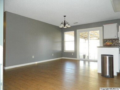 Laminate floors, and new sliding door leading to the backyard.