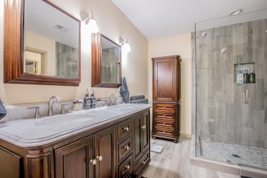 Bathroom with a glass shower stall, double vanity,