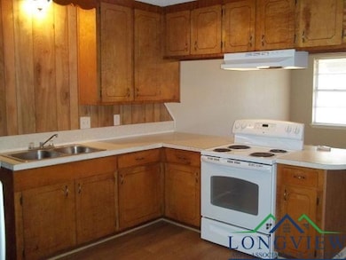 Kitchen with dark wood-type flooring, electric sto