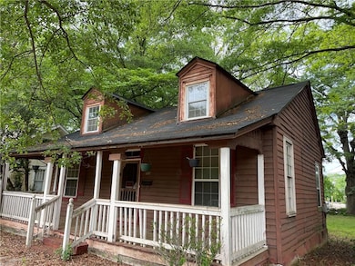 View of front facade with covered porch and roof w