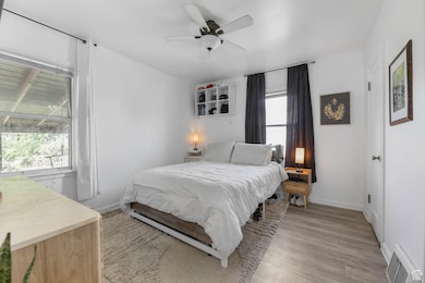 Bedroom featuring light wood-style floors and ceiling fan