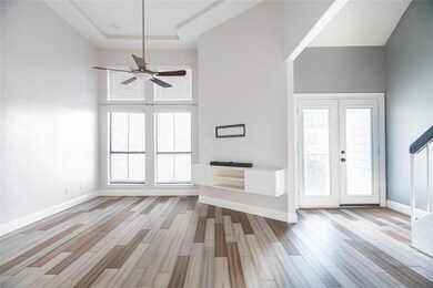 Unfurnished living room featuring ceiling fan, lig