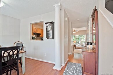Inviting foyer and dining area with decorative pillar and neutral colors!
