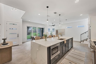 Kitchen featuring a sink, finished concrete floor