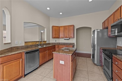 Kitchen featuring a center island, dark stone coun