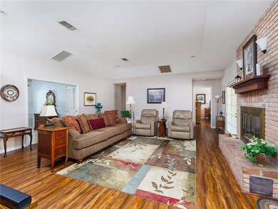 Living room featuring wood-type flooring and a bri