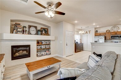 Living area with ceiling fan, light wood-type floo