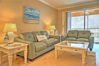 Living room featuring crown molding and wood finished floors