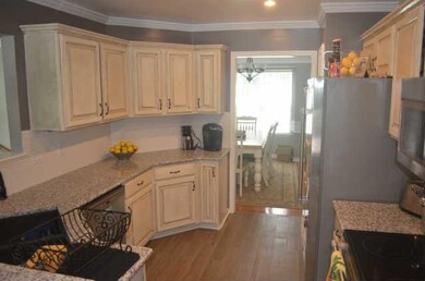 Kitchen work area - plenty of counter space and cabinets plus a pantry.  Counters are all new granite, plus tile backsplash and crown molding are some of the features of this kitchen