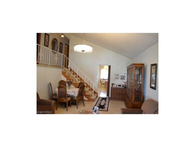Lofted living room with carpeting and opens to the