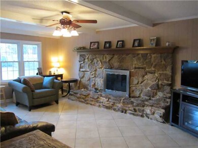 Family room overlooks the pool and back yard and h