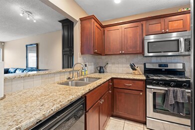 Kitchen featuring appliances with stainless steel