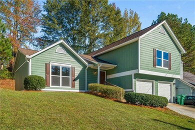 View of front of home with a garage, concrete driv