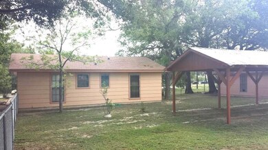 Rear view of property featuring a lawn