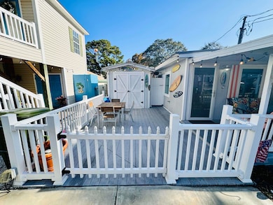 Wooden deck featuring a storage shed