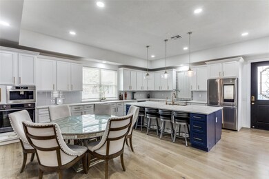 Kitchen featuring stainless steel fridge, decorati