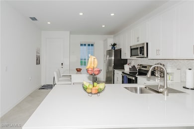 Kitchen with stainless steel appliances, backsplas